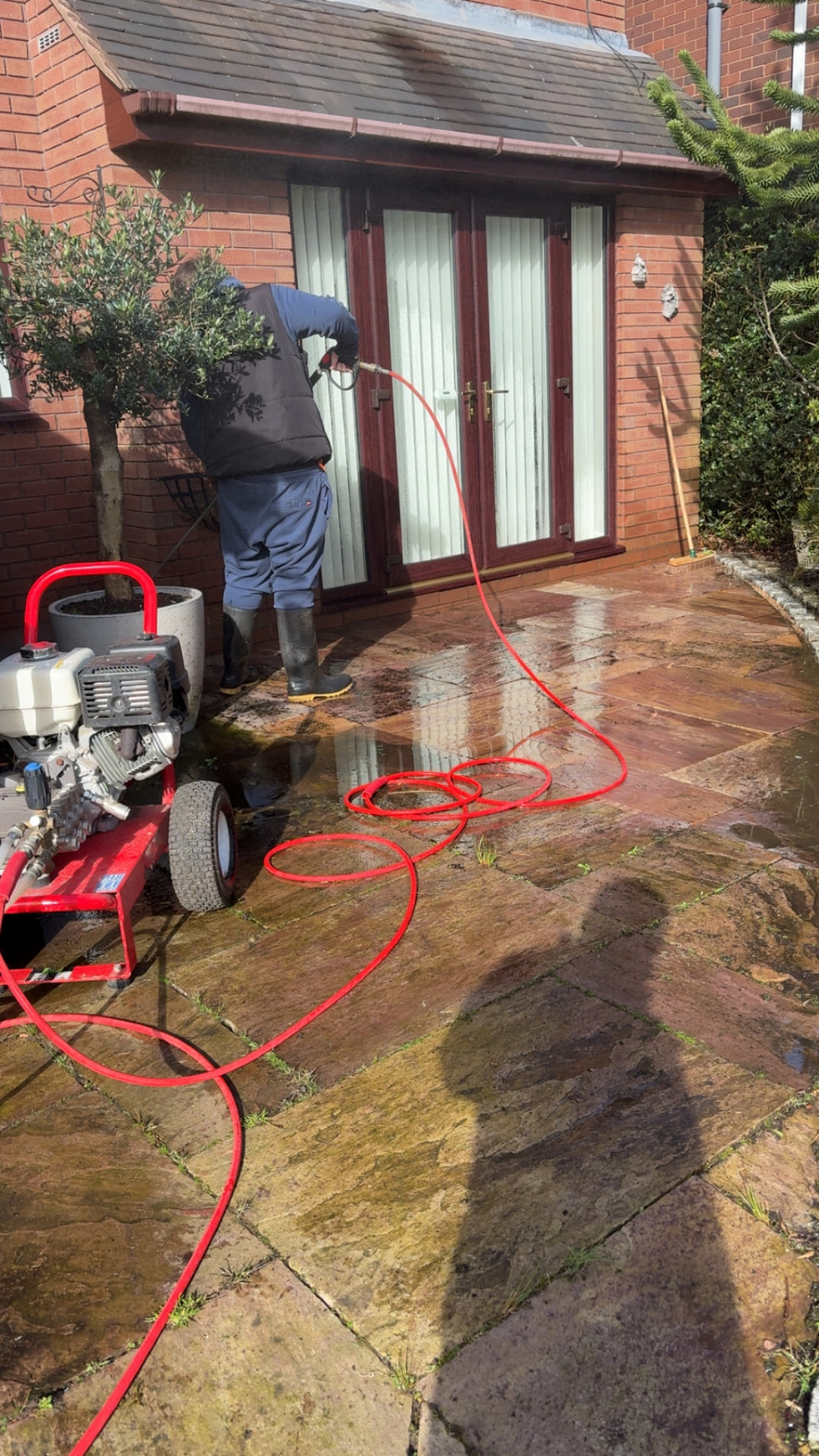 Pressure washing an Indian sandstone patio