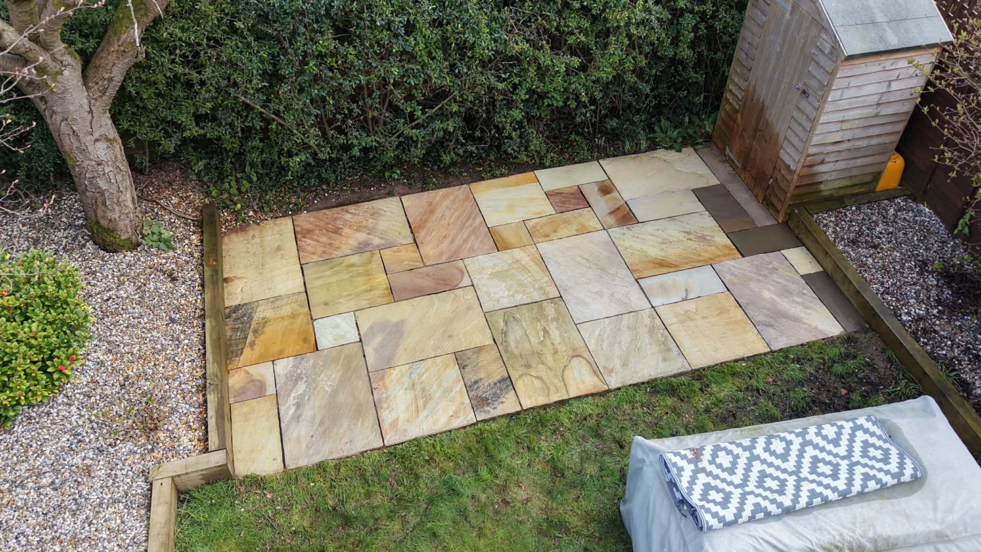 Restored sandstone paving in a rear garden